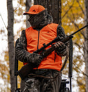 A man wearing an orange vest and hat stands on a chair, promoting Pnuma Outdoor wear.