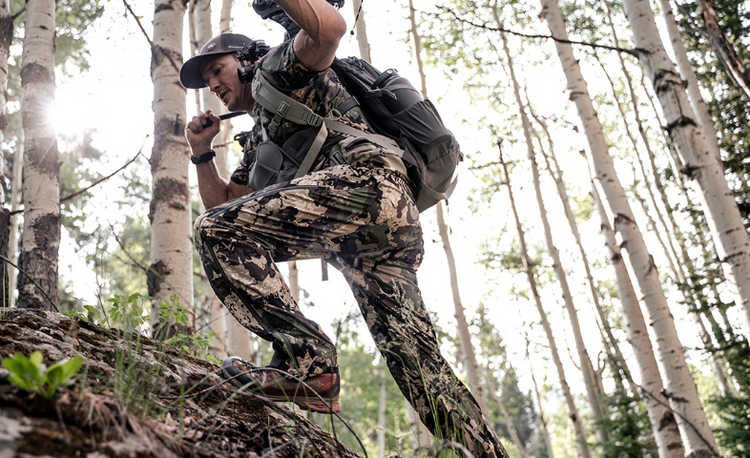 Hunter wearing camouflage as he moves through the forest