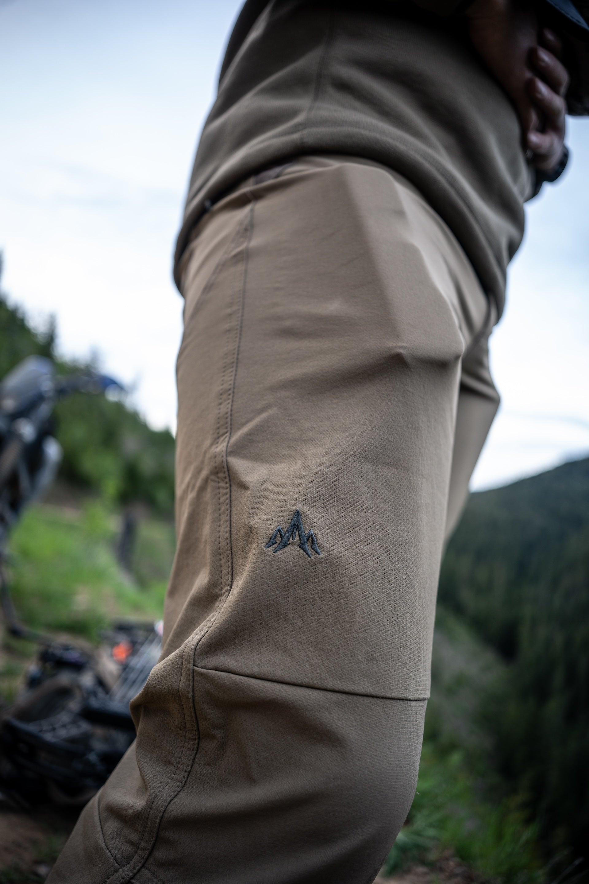 A person stands wearing khaki pants, showcasing a casual and versatile style suitable for various occasions.