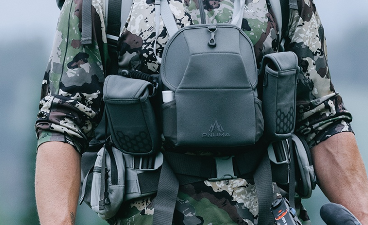 A hunter wearing packs and bags that contain his essential hunting gear